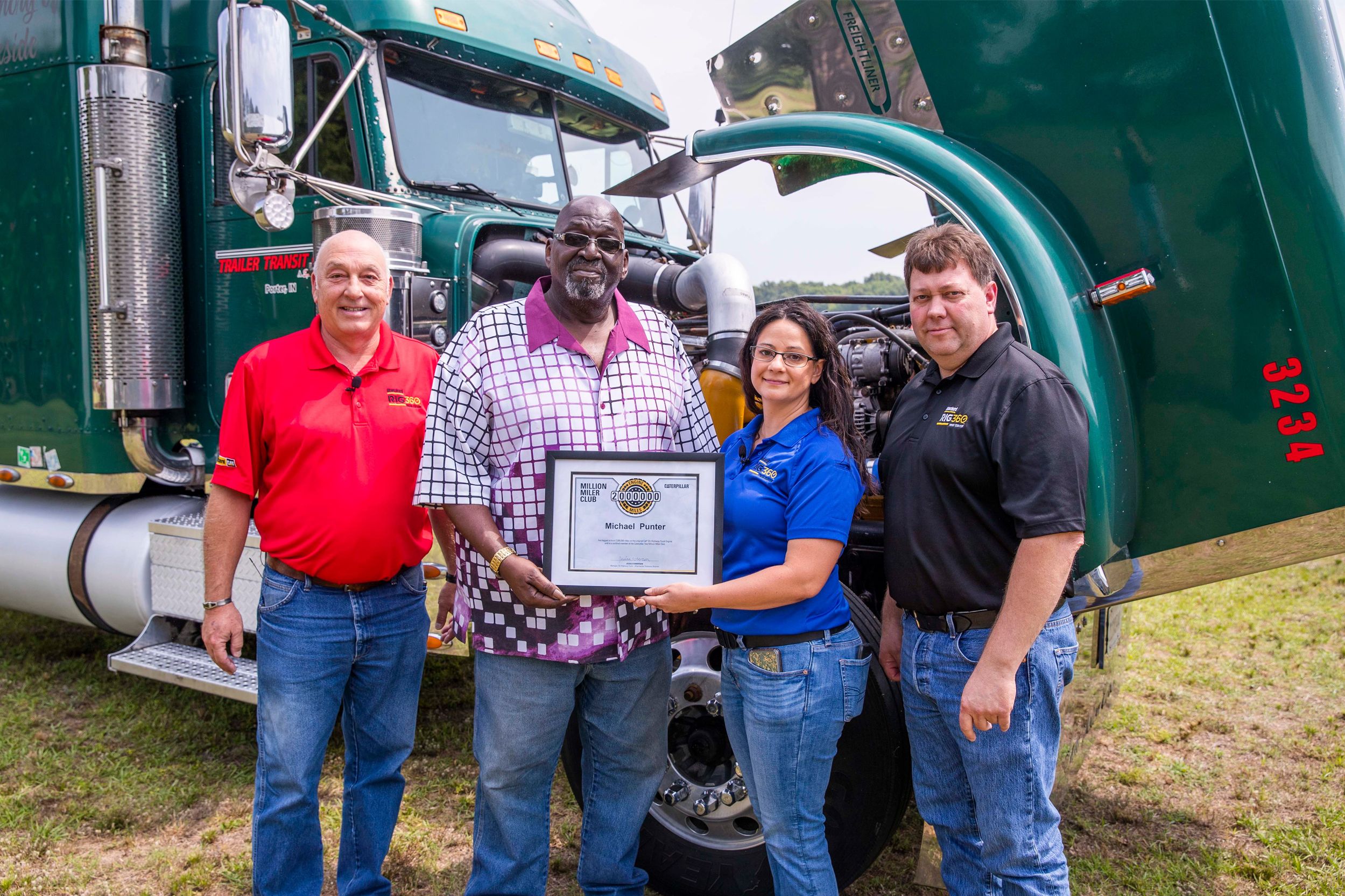 Michael Punter celebrates topping the two-million-mile mark with some of the team members from Blanchard Cat