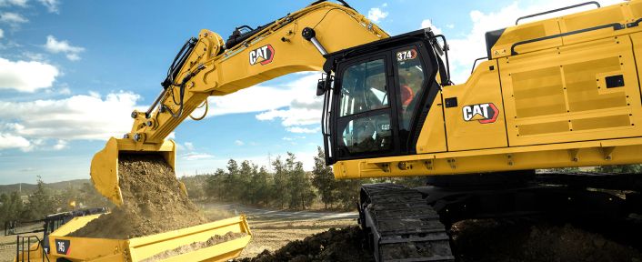Excavator loading dirt into a truck