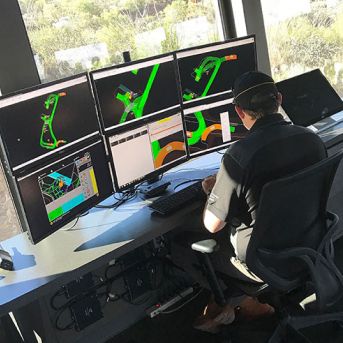 Employee sitting at a bank of monitors