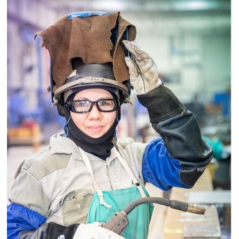 Female employee wearing welding equipment