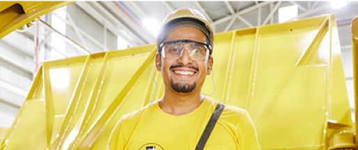 A male employee standing on the production floor