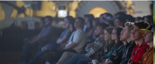 Several people watch a presentation