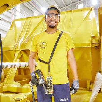 Male employee on the production floor wearing safety gear