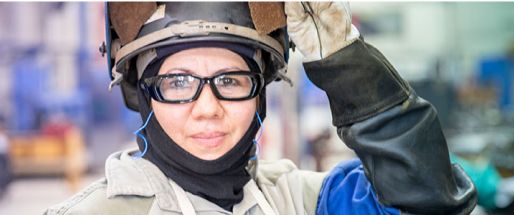Female employee wearing welding equipment