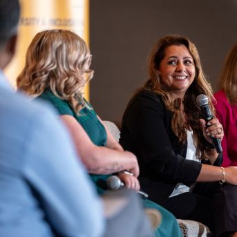 Several female employees talk to each other at a regional diversity & inclusion conference