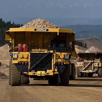 Cat truck driving while loaded with rocks