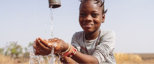 A girl washing her hands in running water