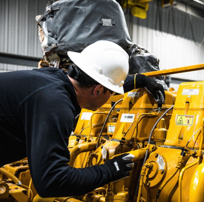 Technician works on a Cat engine
