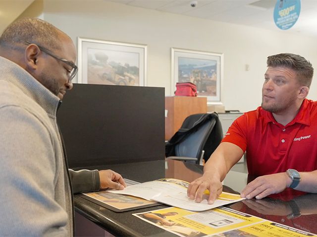 Caterpillar expert meeting with a customer about a rental solution