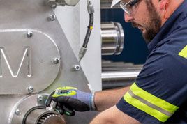 Close up of Cat worker in PPE servicing SPM equipment