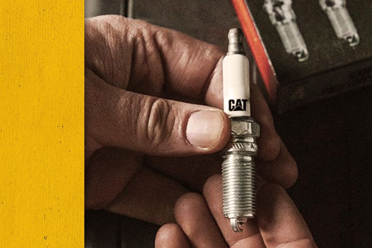 Up close view of a hand holding a Cat Spark Plug