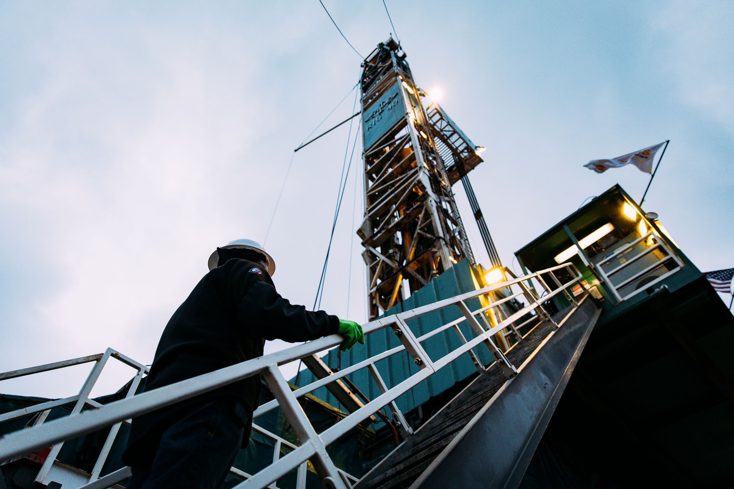 Oil worker climbing stairs on an oil rig