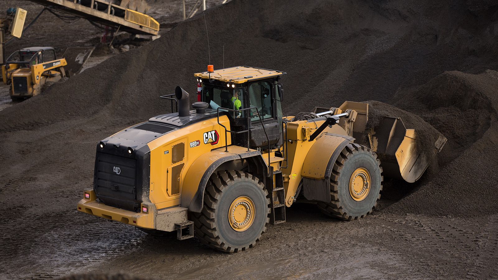 980 XE Wheel Loader dumping dirt on jobsite