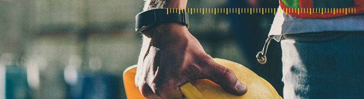 Close-up of man holding a safety hat