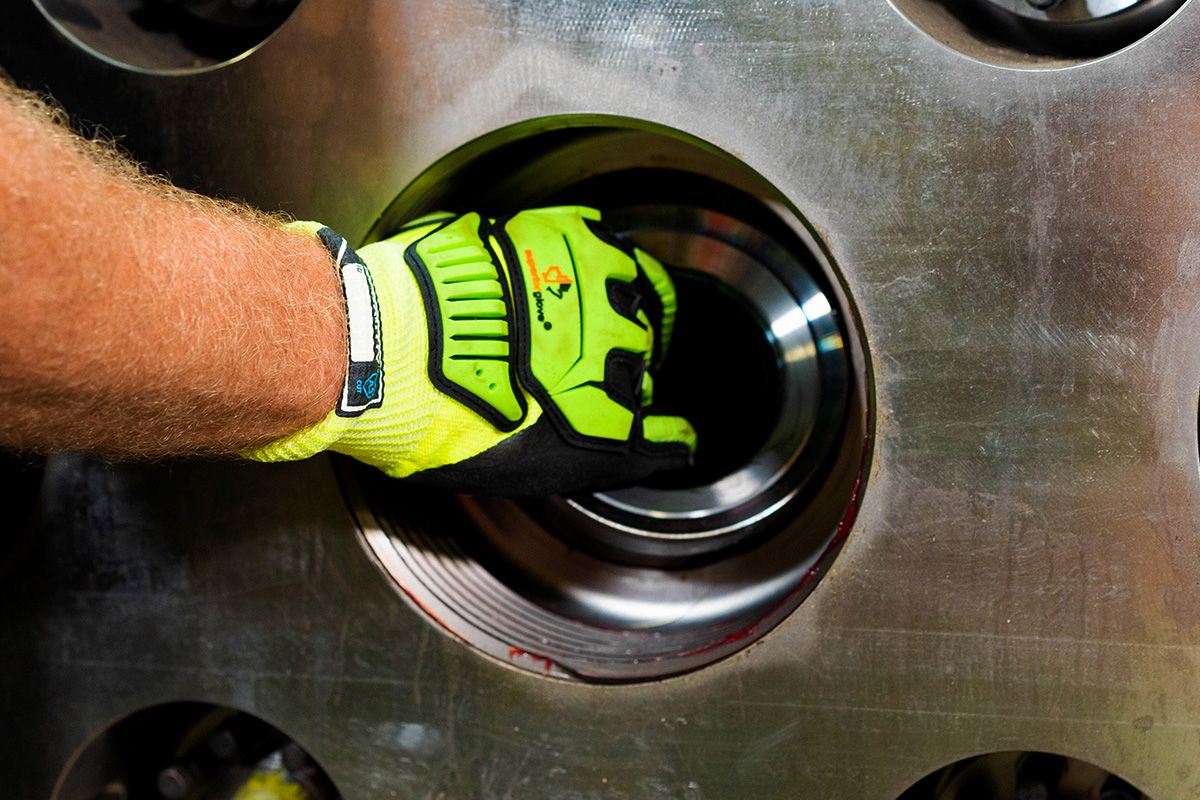 Close up of a gloved hand placing a valve