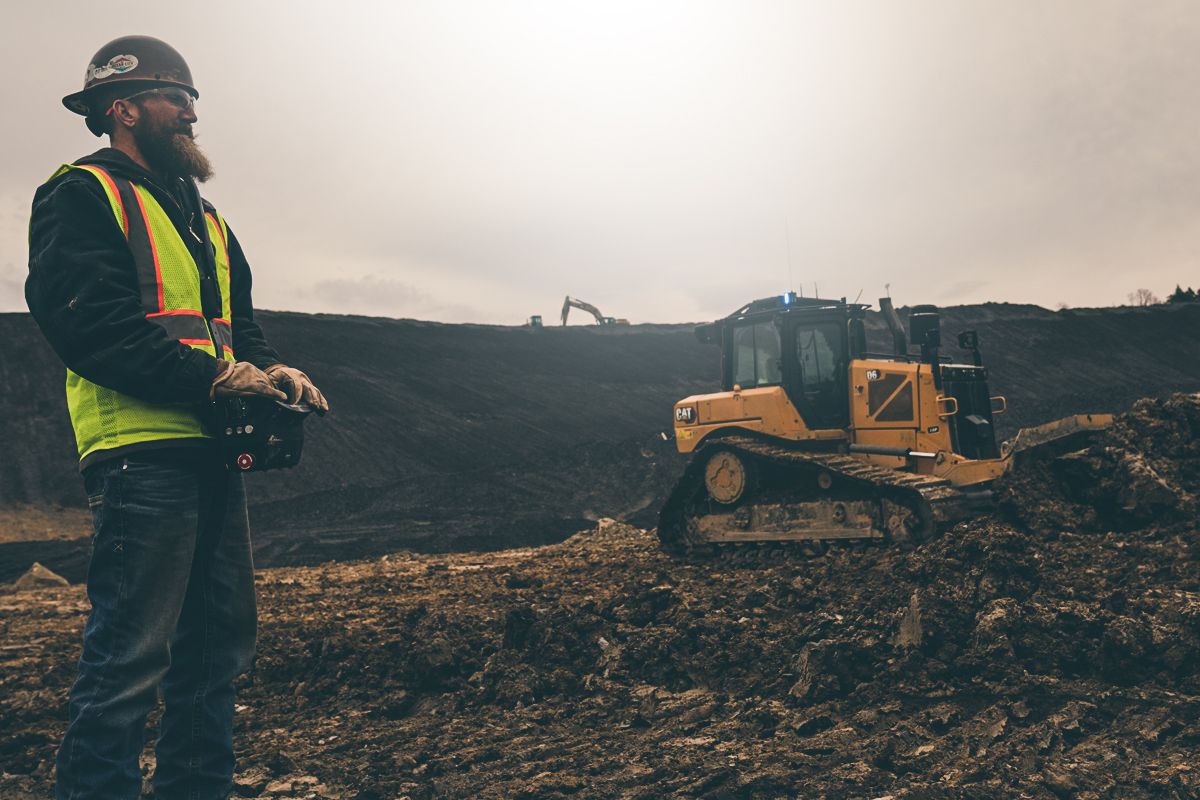 Operator using a Cat Command Console with a dozer