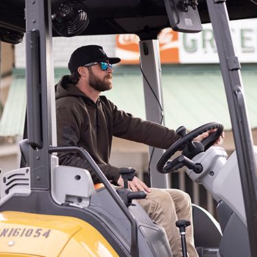 Riley Green operating a Cat machine