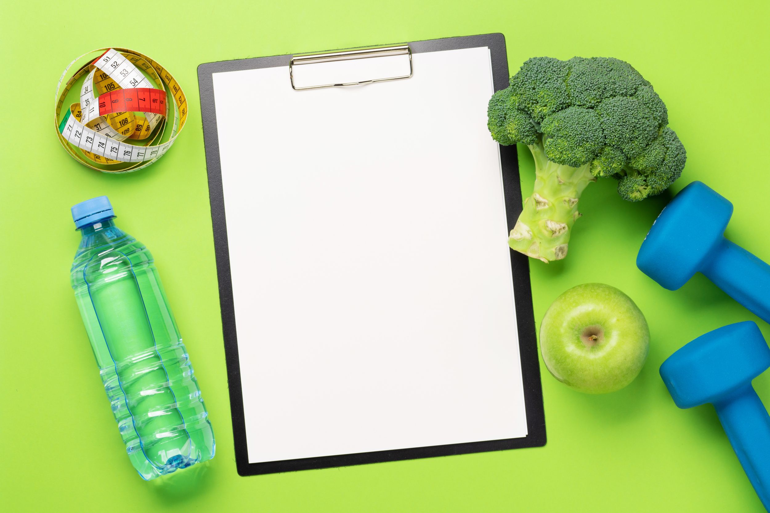 a clipboard, bottle of water, and broccoli