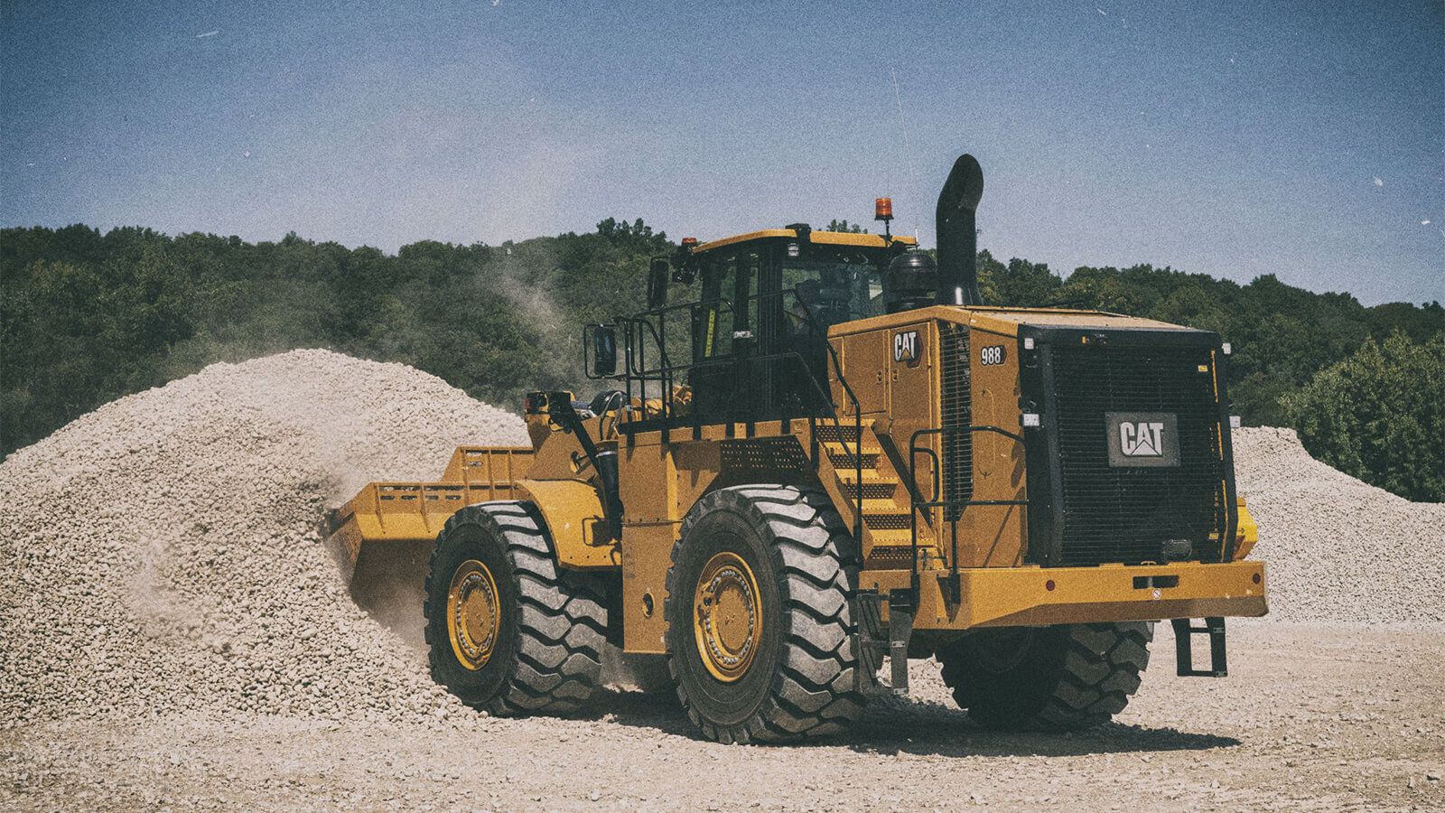 988 Wheel Loader lifting material on jobsite
