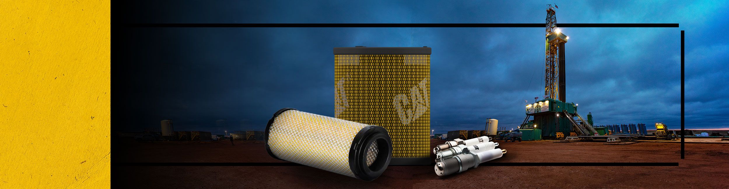 Close up of Cat Oil Filters and Cat Spark Plugs with an oil rig in the background