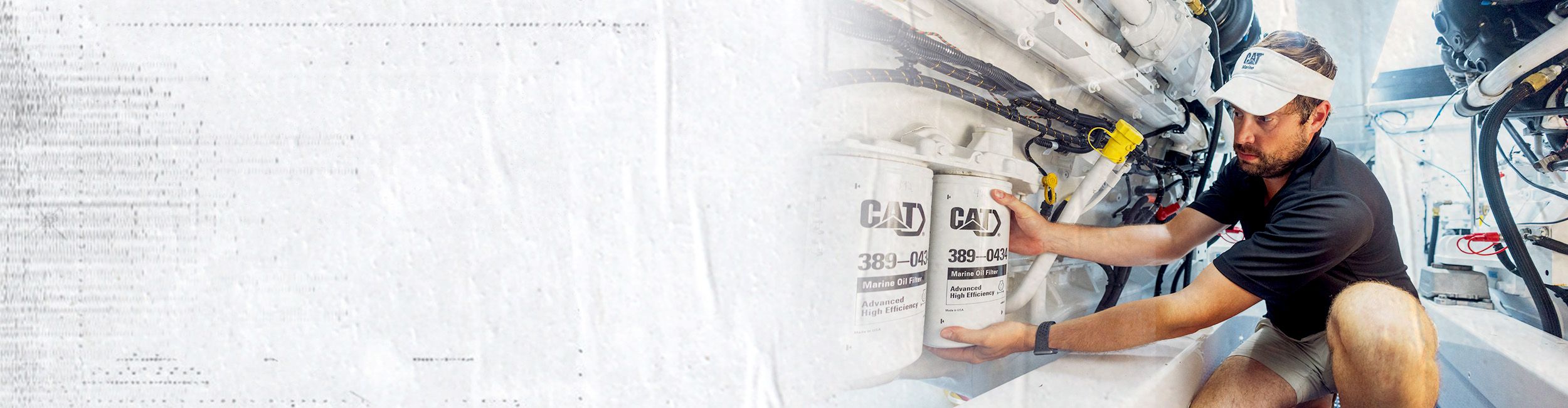 Cat worker installing a Cat Oil Filter on a boat