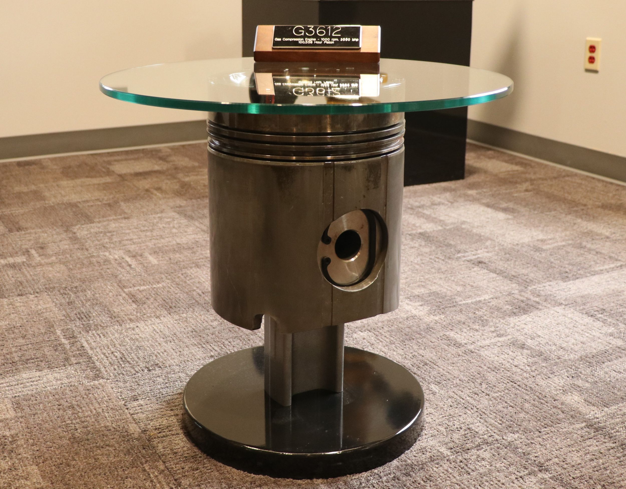 Coffee table made from a Cat G3612 piston usually installed in a gas compression unit