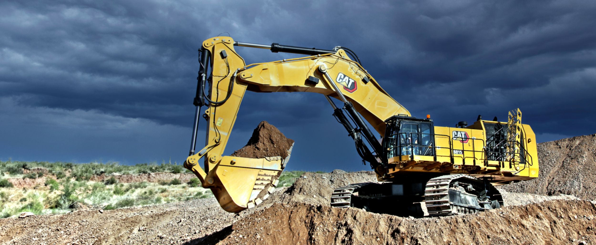 Large Excavator holding large amount of earth in bucket