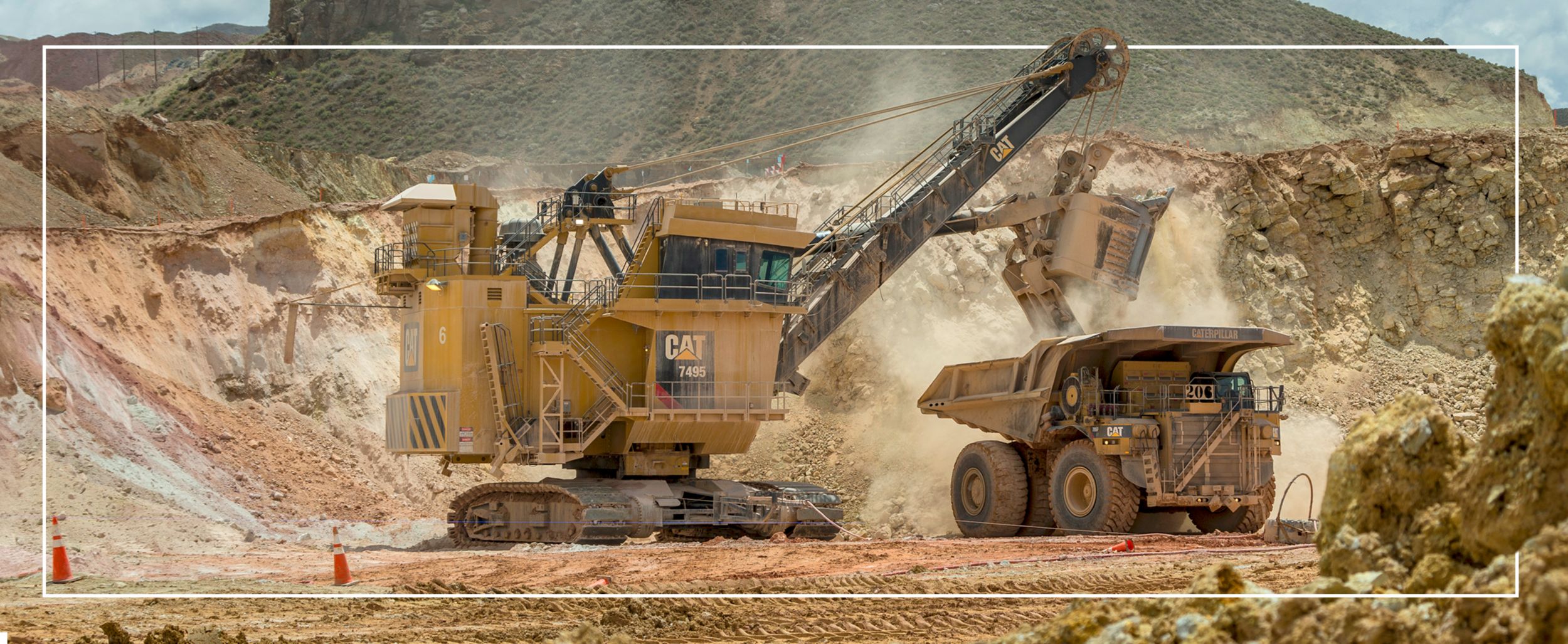 CAT Electric Rope Shovel emptying dirt into a CAT Mining Truck