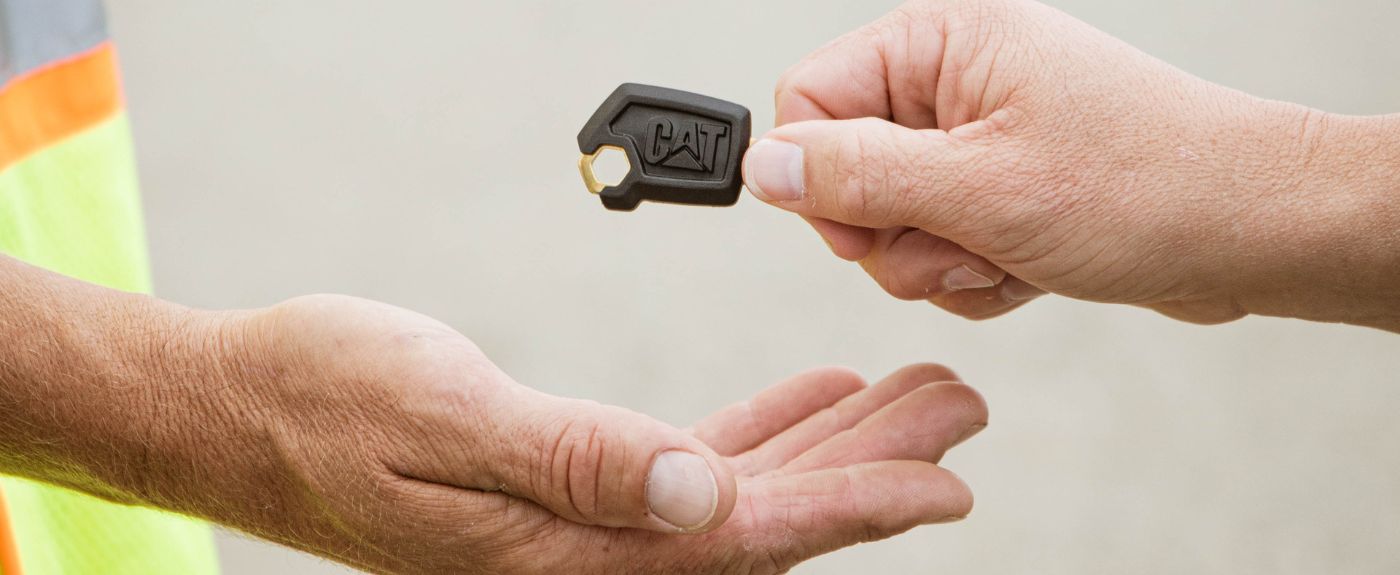 Bronson Koffer of LK & Sons Excavating receiving keys to his first Cat machine