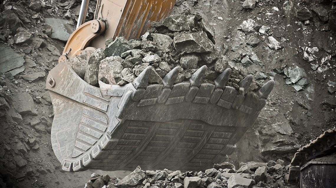 Large Excavator Bucket holding rocks