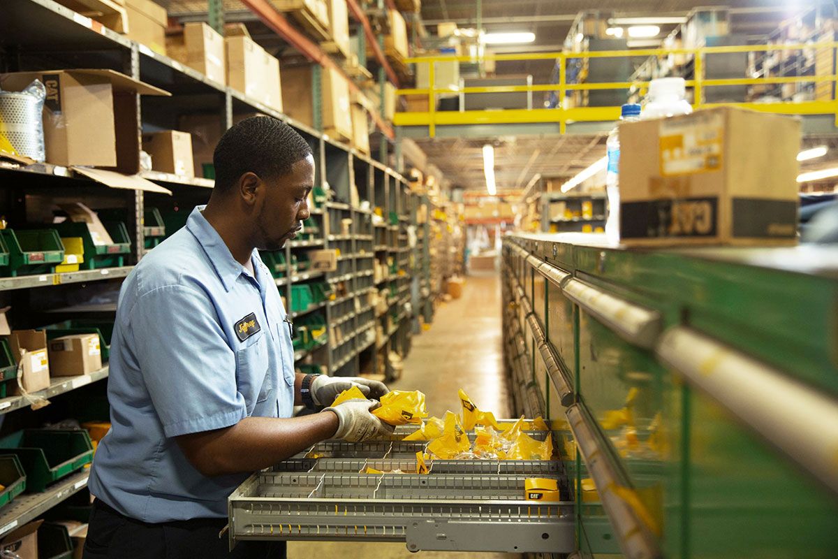 Person sorting Cat parts in a facility