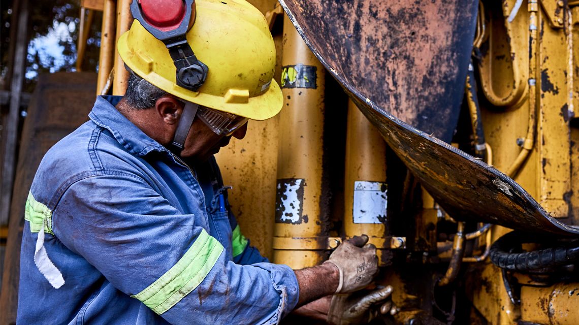 Person Servicing Hydraulics pumps of a Cat Machine