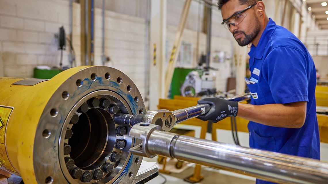 Man servicing powertrain in workshop