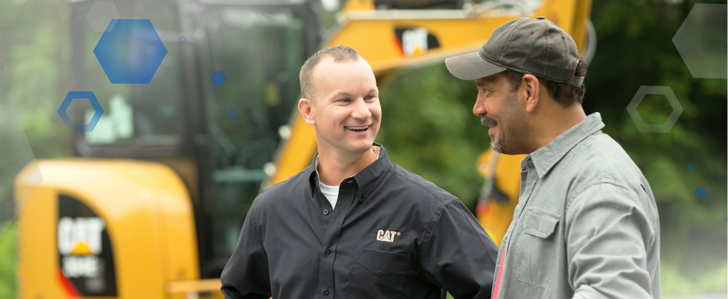 Operator and Cat Employee Talking on a Jobsite