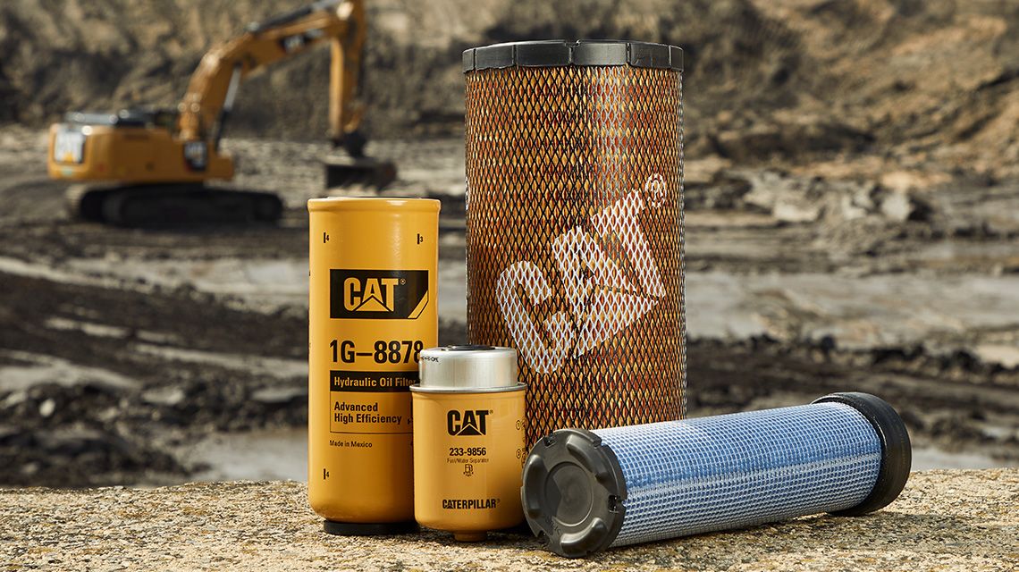 Cat heavy equipment filters displayed on the ground