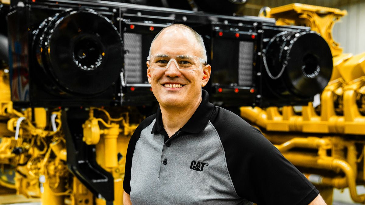 Mark Stein standing in front of an engine