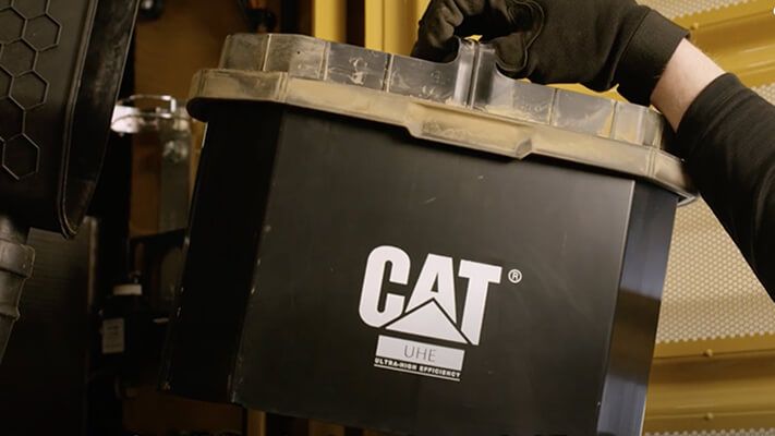 Technician installing an ultra high efficiency (UHE) filter