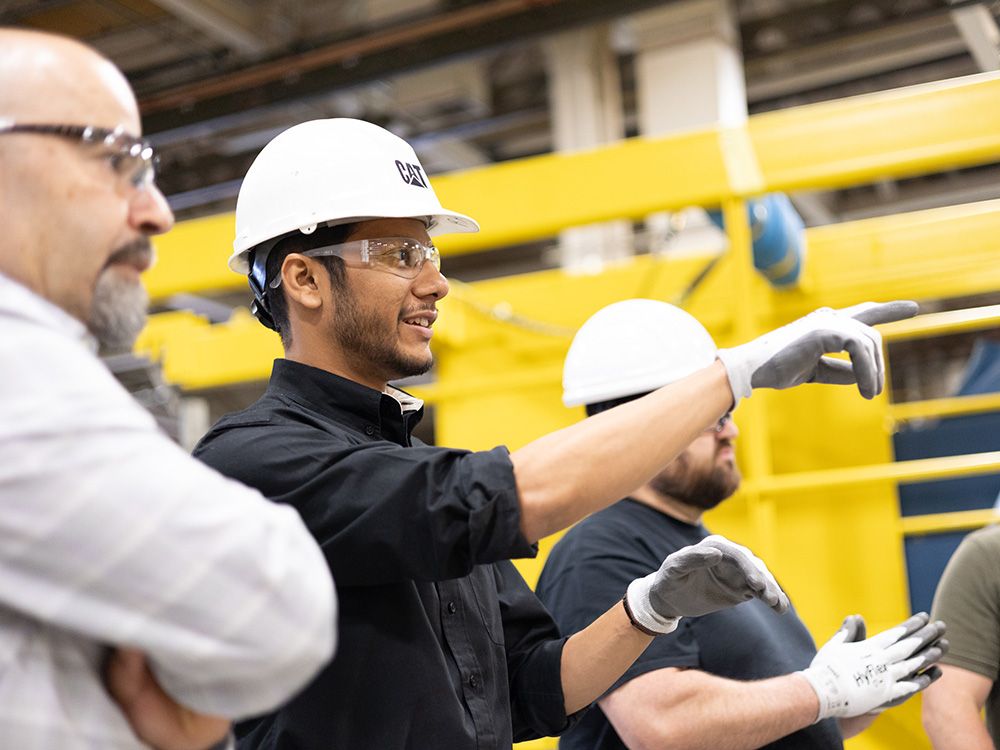 A group of employees wearing safety gear