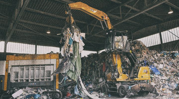 M3022 Excavator lifting concrete dividers on jobsite