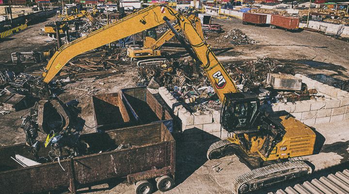 MH3250 Excavator lifting concrete dividers on jobsite