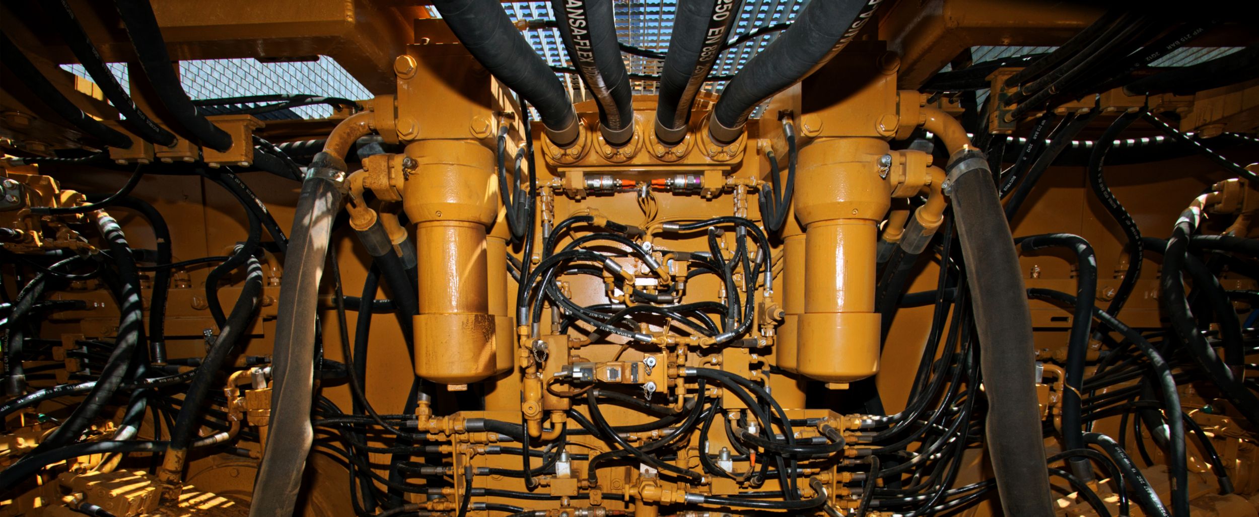 Many valves and hoses attached to cat machine