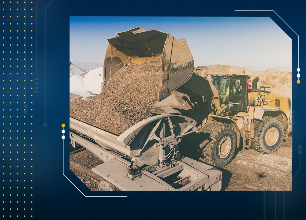 wheel loader dumping material into truck