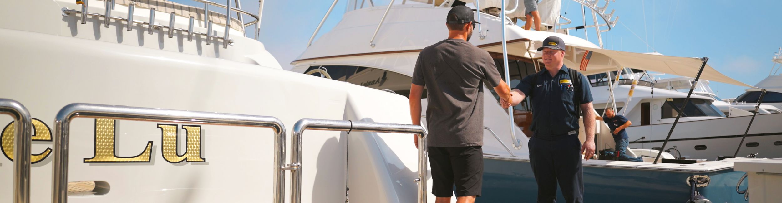 customer and dealer hand shake on back of boat