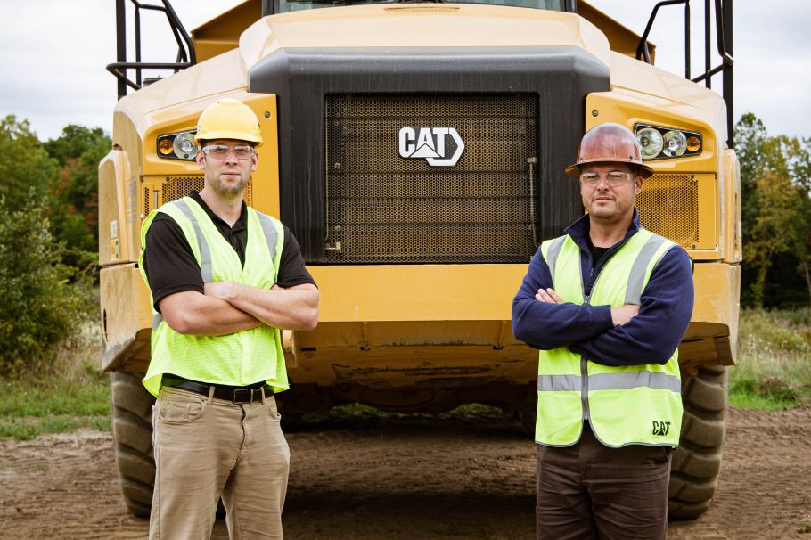 Steve Check of Lakeside Sand & Gravel and Andrew Smith, Ohio Cat Sales Rep standing in front of a Cat machine