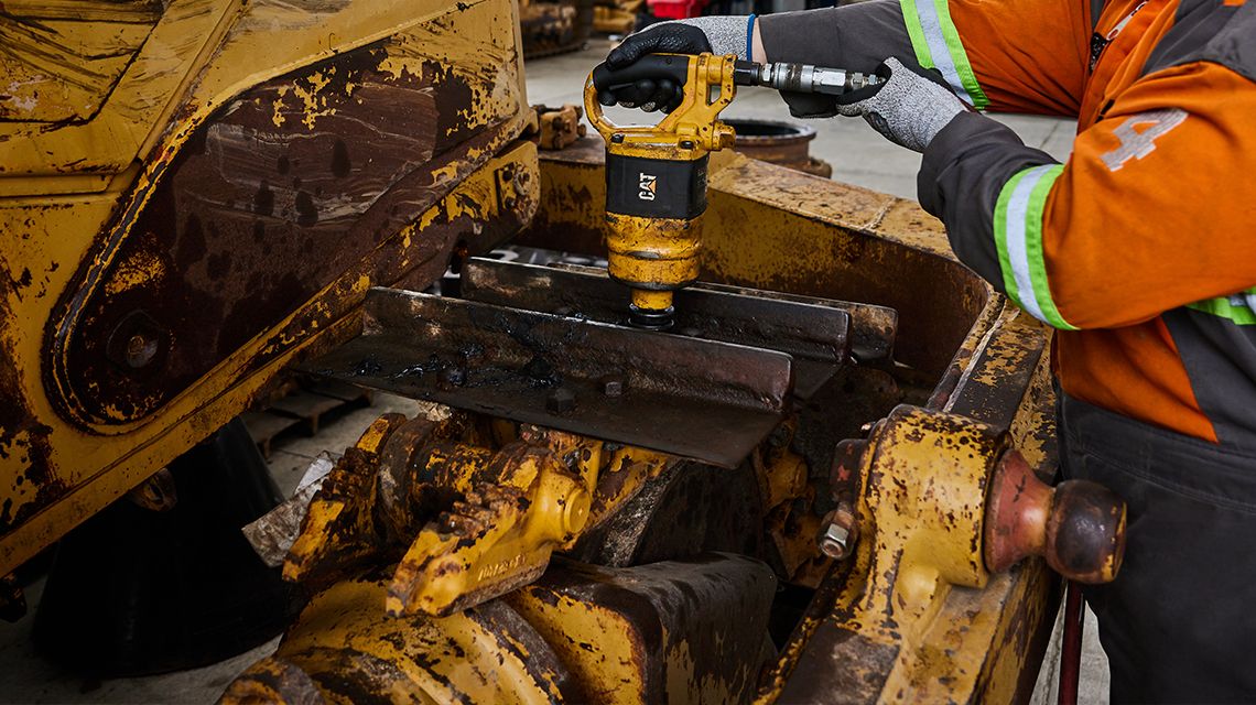 Repair oporator working on a cat mining machine