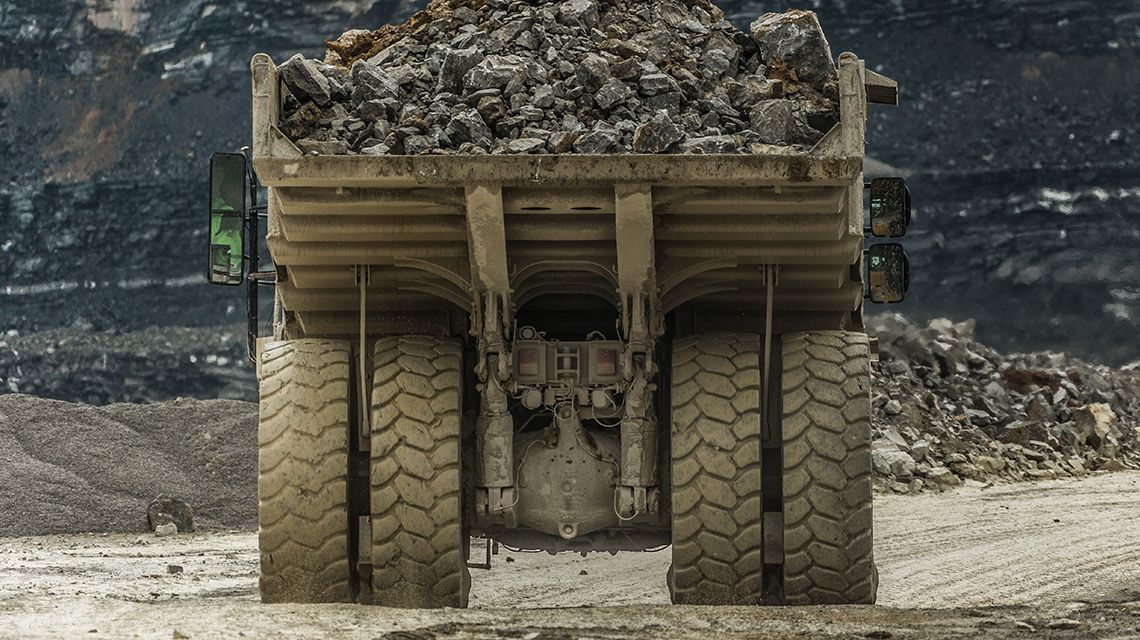 Back side of Cat Mining Truck hauling a full load of rocks