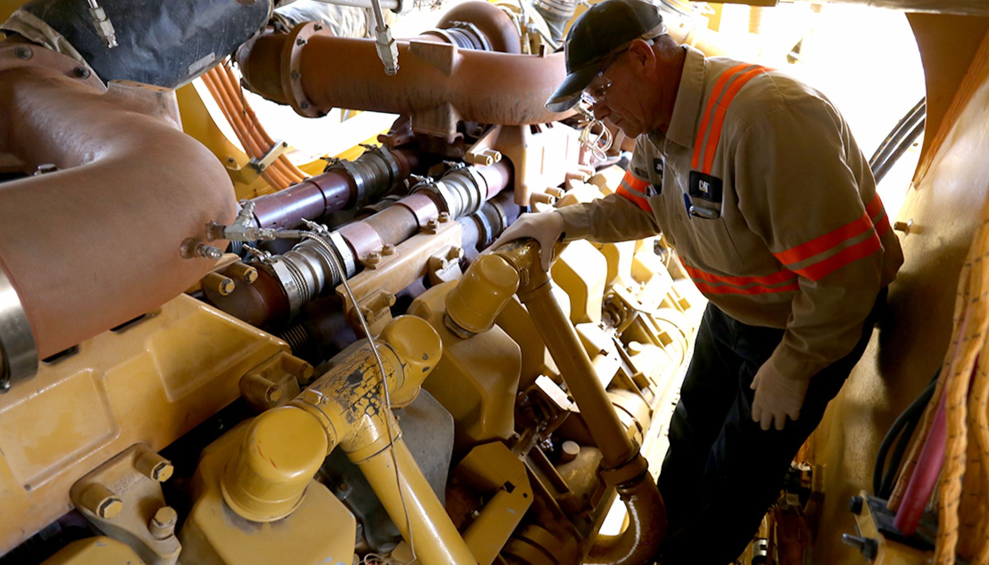 Man Inspecting mining machine parts