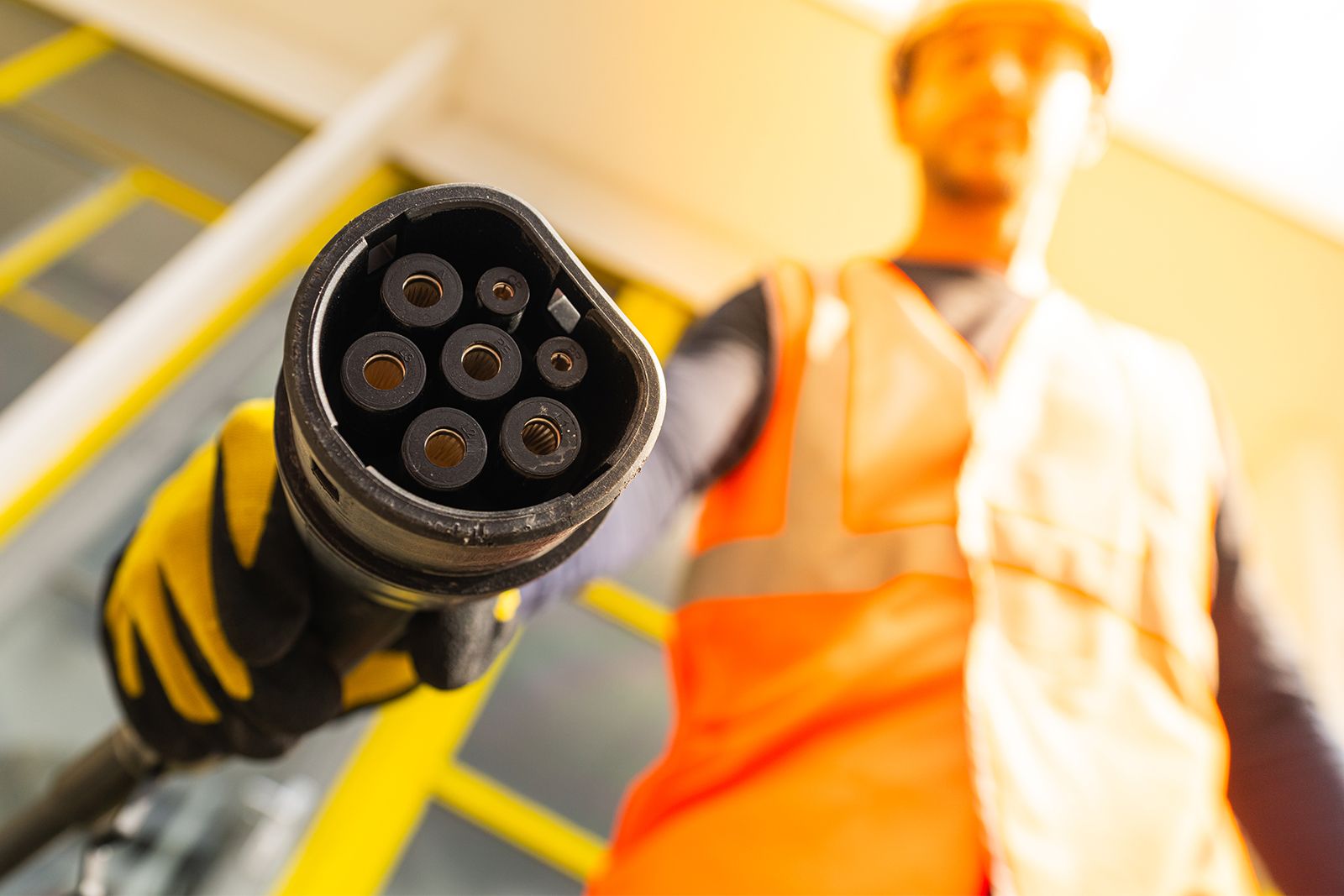 Operator holding a charger for an electric machine