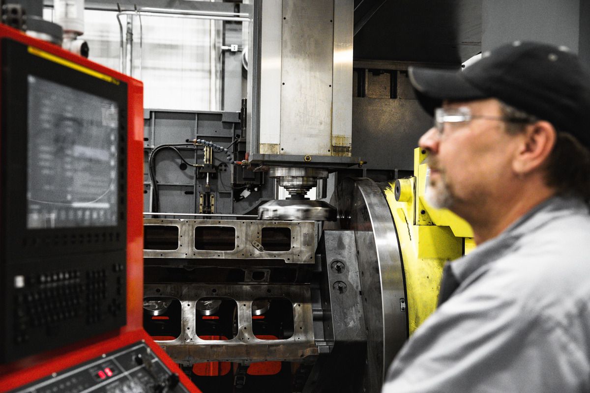 Operator working, looking at controls of an engine