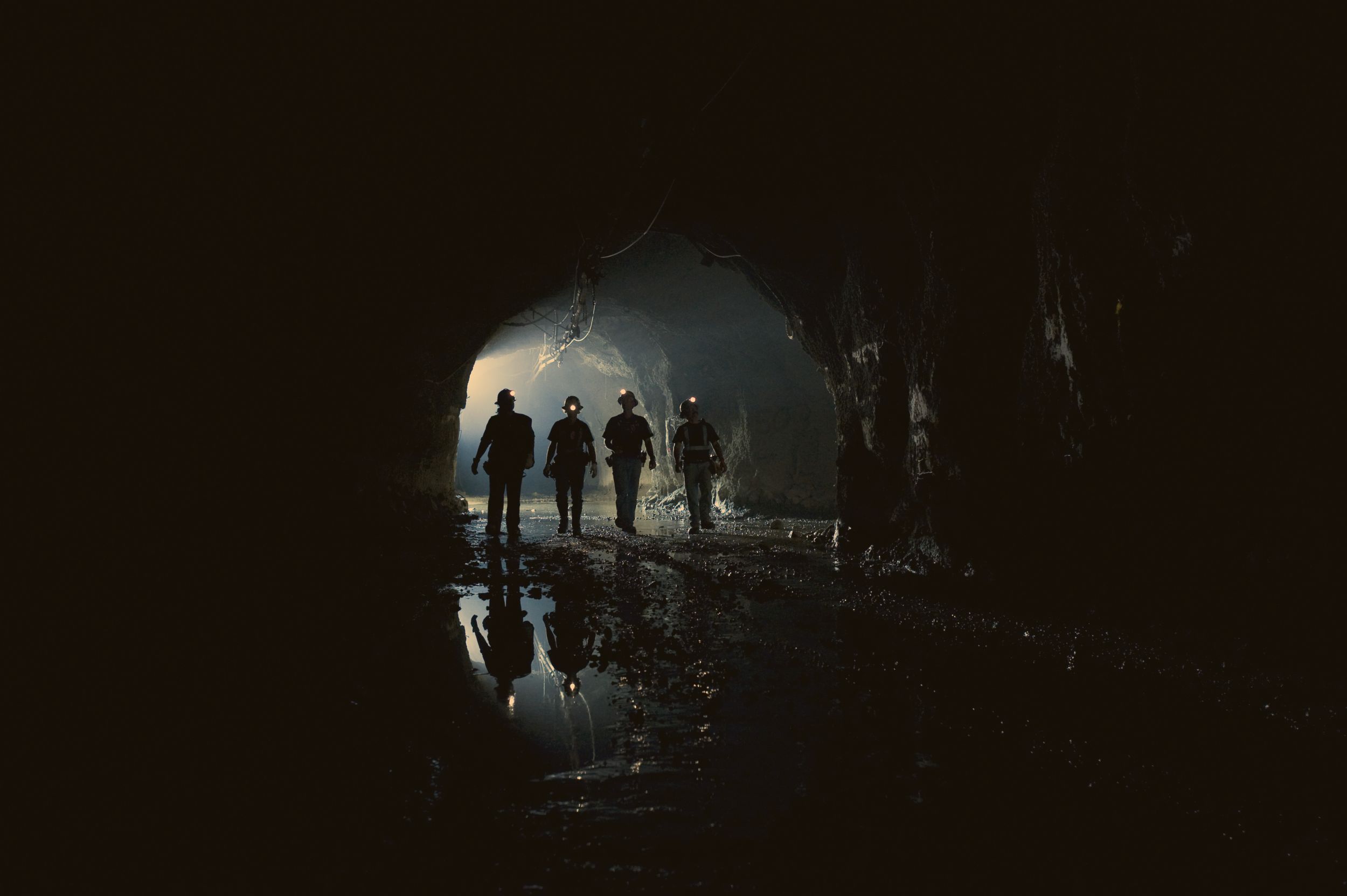 Two people walking on underground mine site